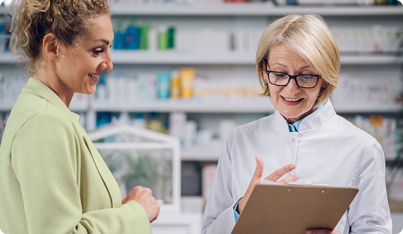 pharmacist and patient looking at tablet