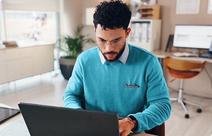 man using laptop in office
