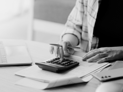 person reading bill using calculator worried