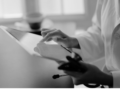 doctor working on tablet accessing data